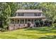 Charming two-story home featuring a spacious front porch and a well-manicured lawn surrounded by mature trees at 408 Camelot Dr, Salisbury, NC 28144