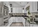 Modern kitchen featuring white cabinets, stainless steel appliances, and granite countertops at 408 Camelot Dr, Salisbury, NC 28144