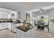 Bright eat-in kitchen features white cabinets, granite countertops, and stainless steel appliances at 408 Camelot Dr, Salisbury, NC 28144