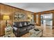 Inviting living room featuring wood paneled walls, hardwood floors, and comfortable seating at 408 Camelot Dr, Salisbury, NC 28144
