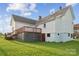 Exterior view of the home's backyard, with a deck and a grass yard at 411 S Central Ave, Landis, NC 28088