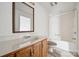 Cozy bathroom featuring vanity with sink, a large mirror and a tub with white shower at 411 S Central Ave, Landis, NC 28088