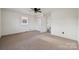 Bedroom with neutral carpet, a window, and a closet, offering a comfortable and functional living space at 411 S Central Ave, Landis, NC 28088