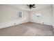 A well-lit bedroom with two windows and neutral carpeting, creating a cozy and inviting space at 411 S Central Ave, Landis, NC 28088