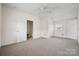 Large bedroom with neutral carpet, ample closet space, and natural light from window at 411 S Central Ave, Landis, NC 28088