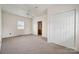 Bright bedroom featuring neutral carpet, double closet, and a view of nearby homes at 411 S Central Ave, Landis, NC 28088