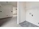 A functional laundry area with tile floors and connections, ready for appliances in a well-lit space at 411 S Central Ave, Landis, NC 28088