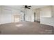 Open living room boasts carpet, neutral walls, fireplace, and a view into other rooms at 411 S Central Ave, Landis, NC 28088