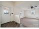 Bright living room featuring neutral walls, carpet, and a ceiling fan for comfortable living at 411 S Central Ave, Landis, NC 28088
