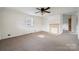 Spacious living room with carpet, neutral walls, a ceiling fan, and a decorative fireplace at 411 S Central Ave, Landis, NC 28088