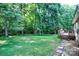 The lush backyard features a well-maintained lawn with mature trees and a deck at 5437 Mallard Ln, Gastonia, NC 28052