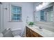 Well-lit bathroom with a wooden vanity, modern fixtures, and a framed mirror at 5437 Mallard Ln, Gastonia, NC 28052