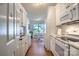 Bright kitchen leading to a dining area, showcasing white appliances and ample cabinet space at 5437 Mallard Ln, Gastonia, NC 28052