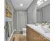 Bathroom with wood vanity, gray walls, gray shower curtain and wood look floors at 5476 Twelve Oak Ln, Conover, NC 28613