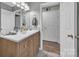 Stylish half-bath features a wood vanity, a white countertop, a modern sink, an elegant mirror, and plenty of natural light at 5476 Twelve Oak Ln, Conover, NC 28613