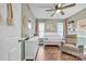Bedroom with light green walls, white trim, wood floors, ceiling fan, crib, dresser and chair at 5476 Twelve Oak Ln, Conover, NC 28613