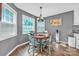 Charming dining area featuring a round table, modern chandelier, and bright natural light from the windows at 5476 Twelve Oak Ln, Conover, NC 28613