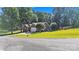 Brick home on a large lot featuring a well-kept lawn, mature trees, and a convenient two-car garage at 5476 Twelve Oak Ln, Conover, NC 28613