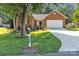 Charming brick home featuring a lush front yard, mature trees, and a two-car garage at 5476 Twelve Oak Ln, Conover, NC 28613