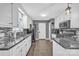 Kitchen featuring white cabinets, gray backsplash, and stainless steel appliances at 5476 Twelve Oak Ln, Conover, NC 28613