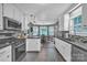Open kitchen with white cabinets, stainless steel appliances, and dining area views at 5476 Twelve Oak Ln, Conover, NC 28613