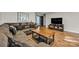 Comfortable living room with a large sectional sofa, hardwood floors, and modern decor at 5476 Twelve Oak Ln, Conover, NC 28613