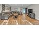 Inviting living room boasting hardwood floors, a large sectional, and a modern entertainment center at 5476 Twelve Oak Ln, Conover, NC 28613