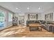 Well-lit living area with hardwood floors, a comfortable couch, and an adjacent dining space at 5476 Twelve Oak Ln, Conover, NC 28613