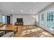 Bright living room with hardwood floors and recessed lighting, offering access to both the yard and hallway at 5476 Twelve Oak Ln, Conover, NC 28613