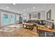 Open-concept living room featuring hardwood floors, a comfortable sectional sofa, and ample natural light at 5476 Twelve Oak Ln, Conover, NC 28613