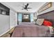 Bedroom with dark wood furniture, ceiling fan, and neutral decor at 5476 Twelve Oak Ln, Conover, NC 28613