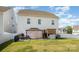 Backyard view of the house, showcasing a covered patio and well-maintained lawn at 5580 Soft Shell Dr, Lancaster, SC 29720