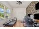 Comfortable bedroom featuring a window with natural light, a futon, and a contemporary accent wall at 5580 Soft Shell Dr, Lancaster, SC 29720
