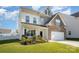 Two-story home with a brick and vinyl facade, two-car garage, and a well-maintained green yard at 5580 Soft Shell Dr, Lancaster, SC 29720