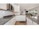 Bright kitchen featuring white cabinets, granite countertops, and stainless steel appliances at 5580 Soft Shell Dr, Lancaster, SC 29720