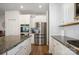 Well-lit kitchen showcasing stainless steel appliances, granite counters, and white cabinets at 5580 Soft Shell Dr, Lancaster, SC 29720
