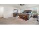 Spacious main bedroom showcasing neutral carpet, two windows, and rustic style furniture at 5580 Soft Shell Dr, Lancaster, SC 29720