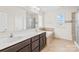 Bright bathroom features a double sink vanity, soaking tub, and a separate shower with glass doors at 586 Brookhaven Dr, Fort Mill, SC 29708