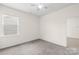 Cozy bedroom features plush carpet, ceiling fan, and a bright window at 586 Brookhaven Dr, Fort Mill, SC 29708