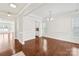 Dining area showcasing hardwood floors, a tray ceiling, a modern chandelier, and great natural lighting at 586 Brookhaven Dr, Fort Mill, SC 29708