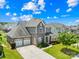 Beautiful two-story home with a well-manicured lawn, complemented by mature trees and a three-car garage at 586 Brookhaven Dr, Fort Mill, SC 29708