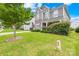 Well-manicured front lawn of home featuring trimmed hedges, a mature tree and lush green grass at 586 Brookhaven Dr, Fort Mill, SC 29708
