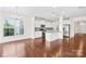 Bright, open-concept kitchen with white cabinets, granite countertops, and stainless steel appliances at 586 Brookhaven Dr, Fort Mill, SC 29708
