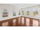 Bright and spacious living room with hardwood floors and multiple windows offering plenty of natural light at 586 Brookhaven Dr, Fort Mill, SC 29708