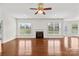 Bright and airy living room boasts hardwood floors, a ceiling fan, and a fireplace for a cozy ambiance at 586 Brookhaven Dr, Fort Mill, SC 29708
