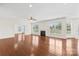 Spacious living room featuring a fireplace, gleaming hardwood floors, and large windows for ample natural light at 586 Brookhaven Dr, Fort Mill, SC 29708