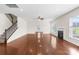 Warm living room featuring hardwood floors, fireplace, and stairs to the upper level at 586 Brookhaven Dr, Fort Mill, SC 29708