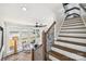 Inviting room with lake views, a staircase, wood accents, and a ceiling fan at 5985 Natoma Rd, Clover, SC 29710