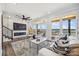 Cozy living room with a fireplace, plush seating, and large windows with water views at 5985 Natoma Rd, Clover, SC 29710