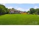Spacious rear exterior of home overlooking large lawn extending to the lake at 5985 Natoma Rd, Clover, SC 29710